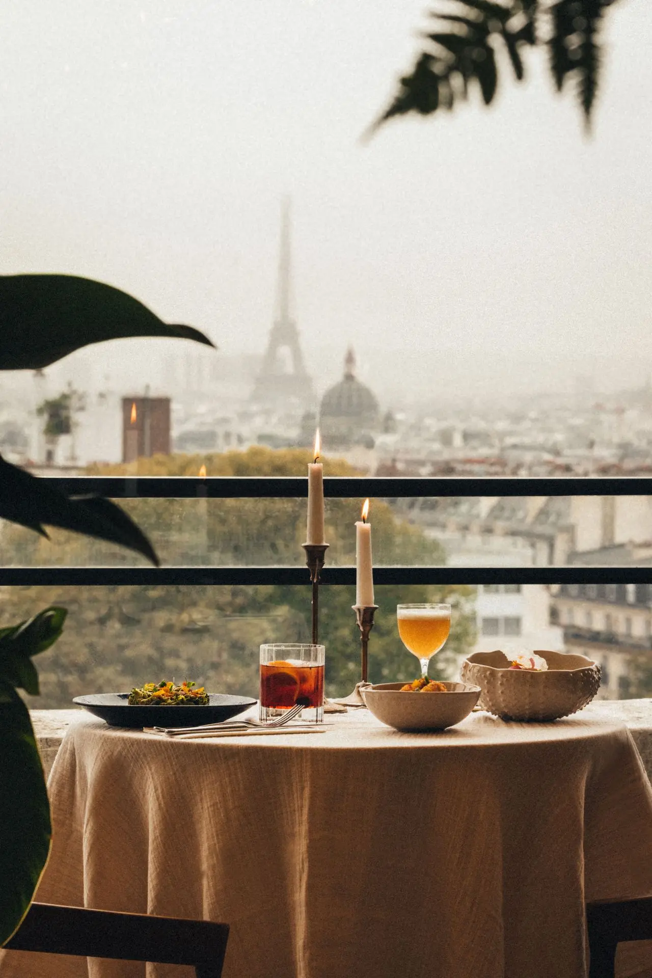 “View of the Eiffel Tower from the Terrass Hôtel rooftop bar in Montmartre, Paris, at sunset.”